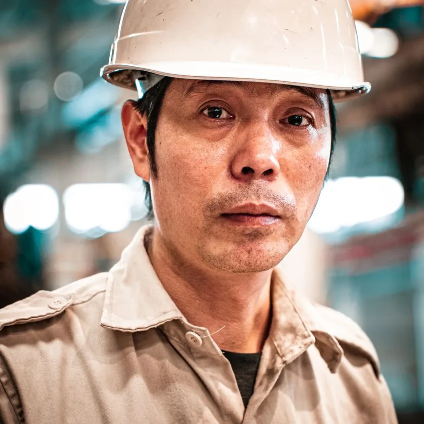 Portrait of an L&H trade worker in a hard hat