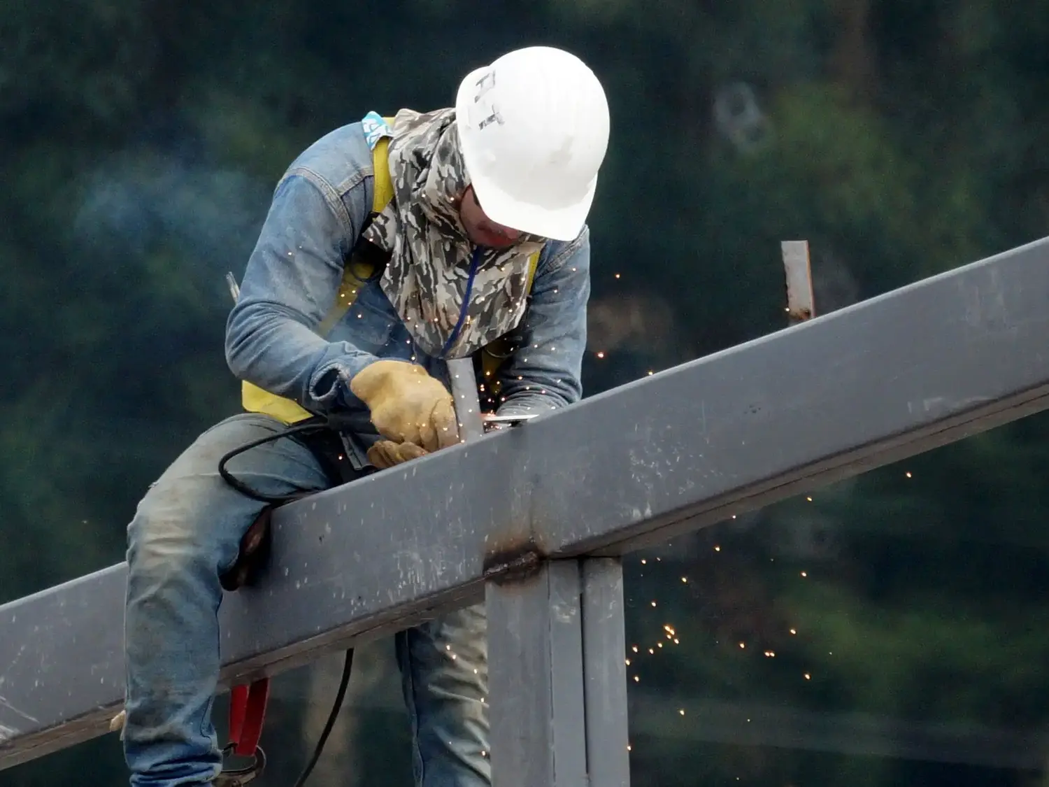 Welder working on a structural steel beam